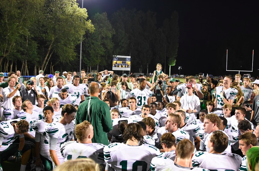 Coach Gerry Romberg talks to the Cats after the game