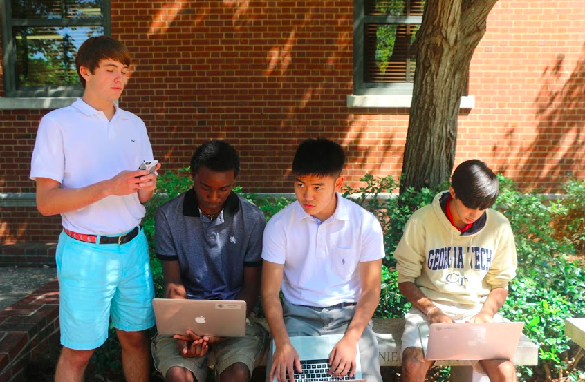 Juniors Colby Webb, Michael McGovern, David Choi and Ajay Manocha check their fantasy football stats. 