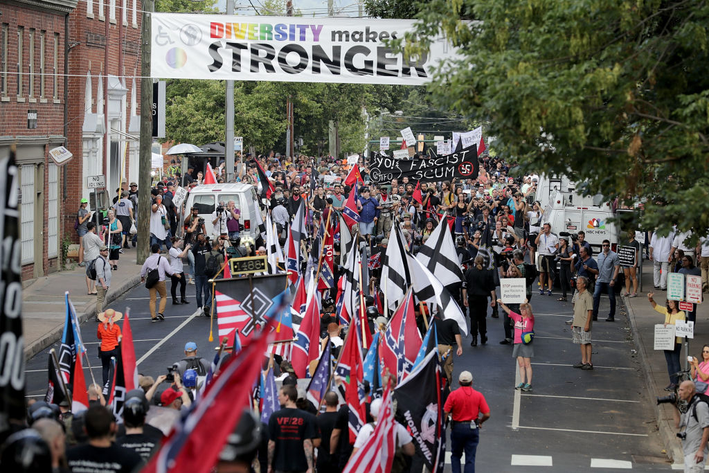 CHARLOTTESVILLE, VA - AUGUST 12:  Hundreds of white nationalists, neo-Nazis and members of the alt-right march down East Market Street toward Lee Park during the Unite the Right rally August 12, 2017 in Charlottesville, Virginia. After clashes with anti-fascist protesters and police the rally was declared an unlawful gathering and people were forced out of Lee Park, where a statue of Confederate General Robert E. Lee is slated to be removed.  (Photo by Chip Somodevilla/Getty Images)