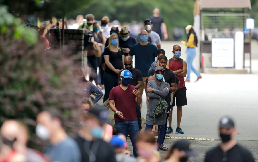 Voters in Georgia wait in extensive lines to cast polls.