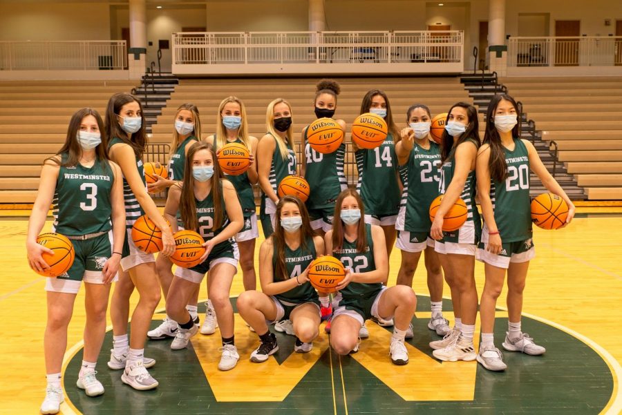 The girls basketball team looks fierce under their masks as they pose for a team shot. 
Credit Randy Schiff
