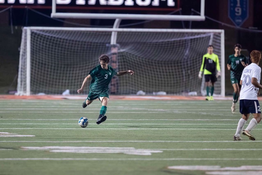 Noah Cooney crosses the ball deep to his teammates in the State Championship game.
