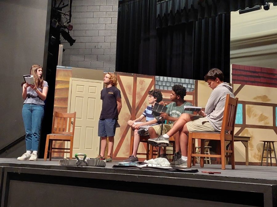 The cast of Upper School’s most recent play, “Mrs. Packard” rehearse for the scene in which Mrs. Packard (Annalise Jones ‘23, far left) pleads her sanity to Doctor McFarland (Reese Norman ‘23, center), and the trustees. 