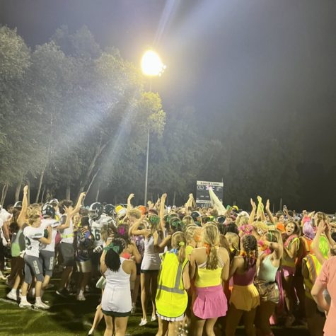 Fans, players, cheerleaders, and managers storm the field after the Wildcats win 14-0 against the Lovett Lions. 