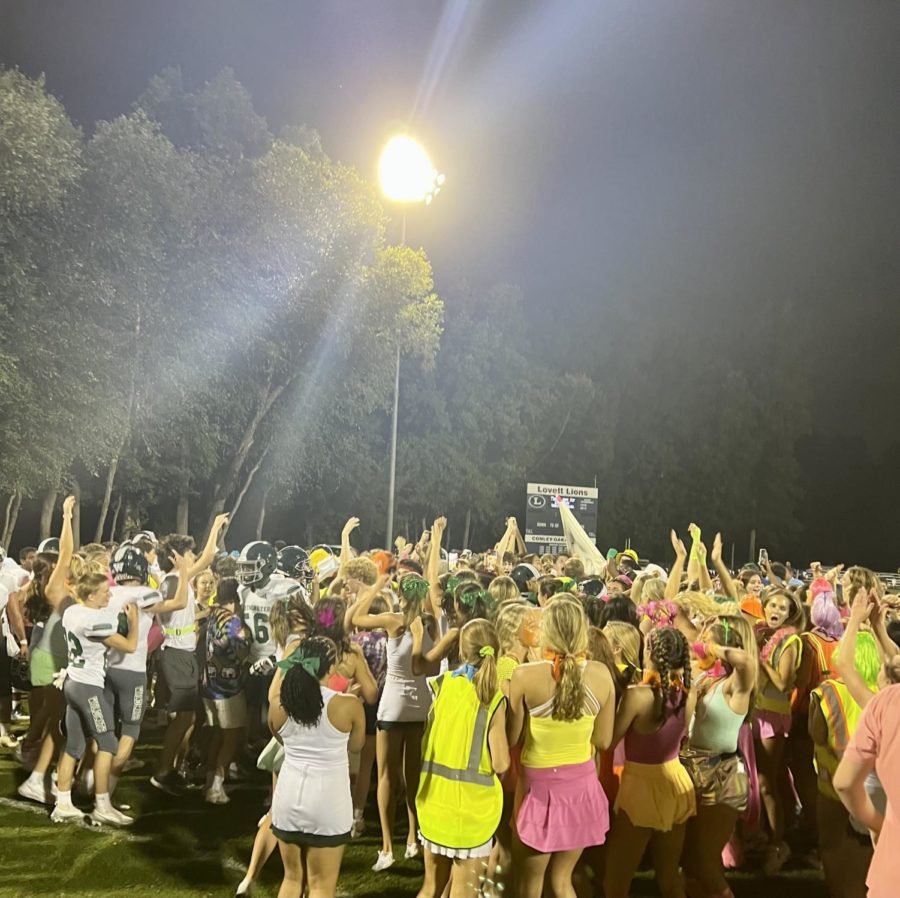 Fans, players, cheerleaders, and managers storm the field after the Wildcats win 14-0 against the Lovett Lions. 