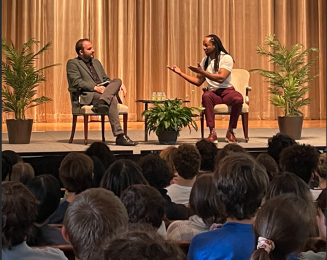 Mario Chard interviews Jericho Brown during an assembly
