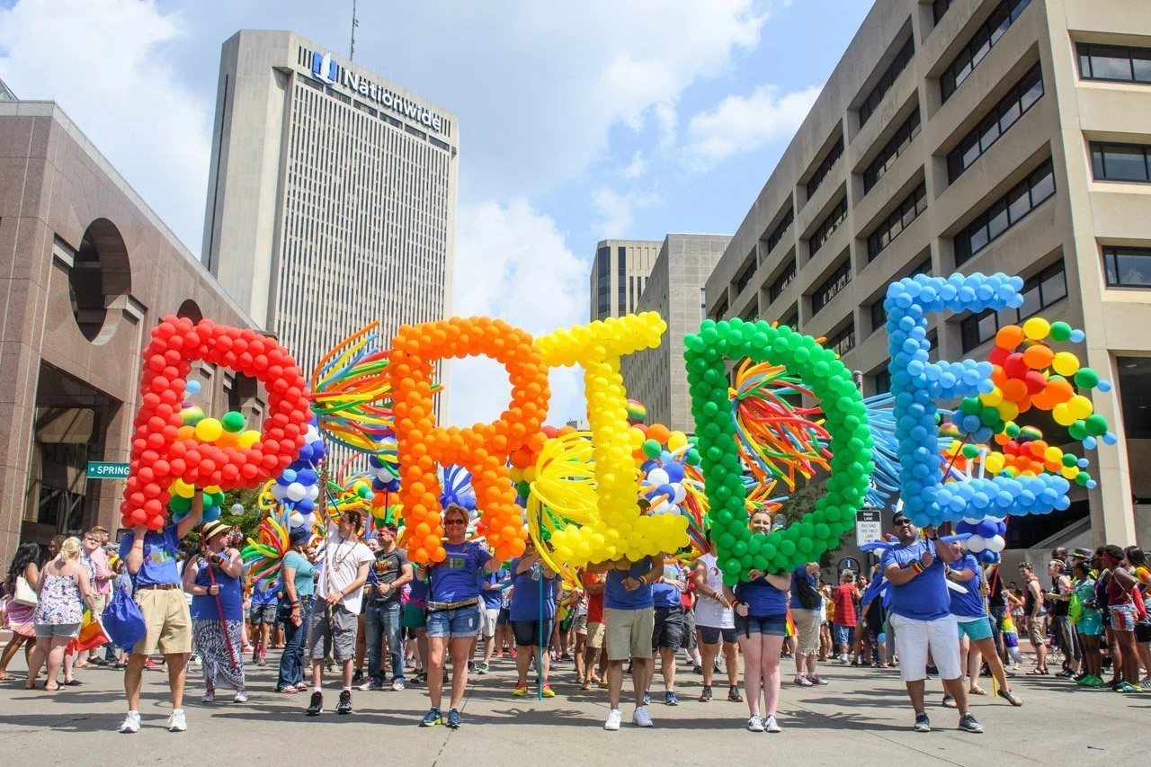 The Pride March in Colombus, Ohio with the word PRIDE spelled out in large. Courtesy of Colombus Underground. 